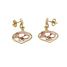 Load image into Gallery viewer, Bring symbolic beauty and graceful detail to your collection with these pre-owned 9ct yellow and rose gold Clogau Tree of Life drop earrings—a meaningful design inspired by nature and connection.

Design: Each earring features the iconic Tree of Life motif, combining flowing vines and leaves in a delicate openwork drop style.
Material: Made from 9-carat yellow and rose gold, the contrasting tones highlight the intricate design and signature Clogau detail.

