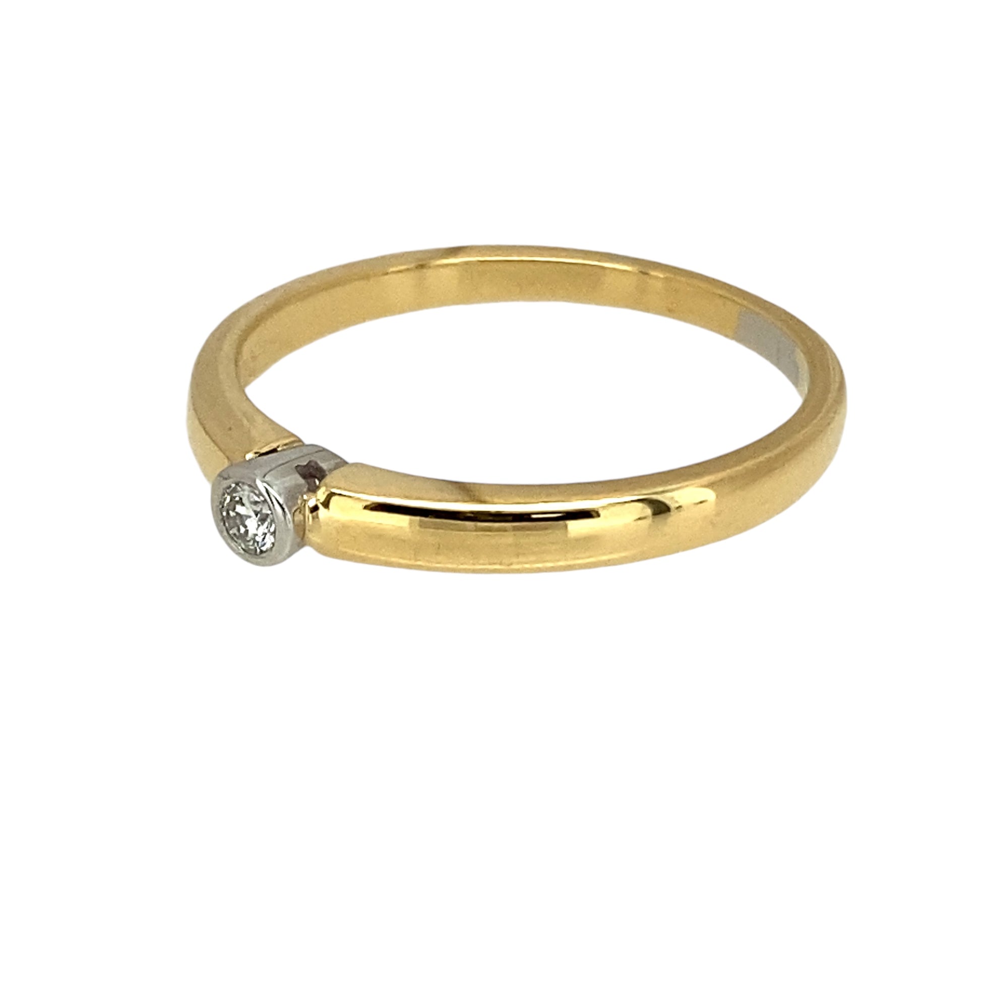 Preowned 18ct Yellow and White Gold & Diamond Rubover Set Dainty Solitaire Ring in size N with the weight 2.70 grams. The diamond is approximately 5pt and is rubover set