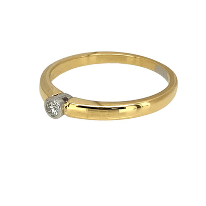 Preowned 18ct Yellow and White Gold & Diamond Rubover Set Dainty Solitaire Ring in size N with the weight 2.70 grams. The diamond is approximately 5pt and is rubover set