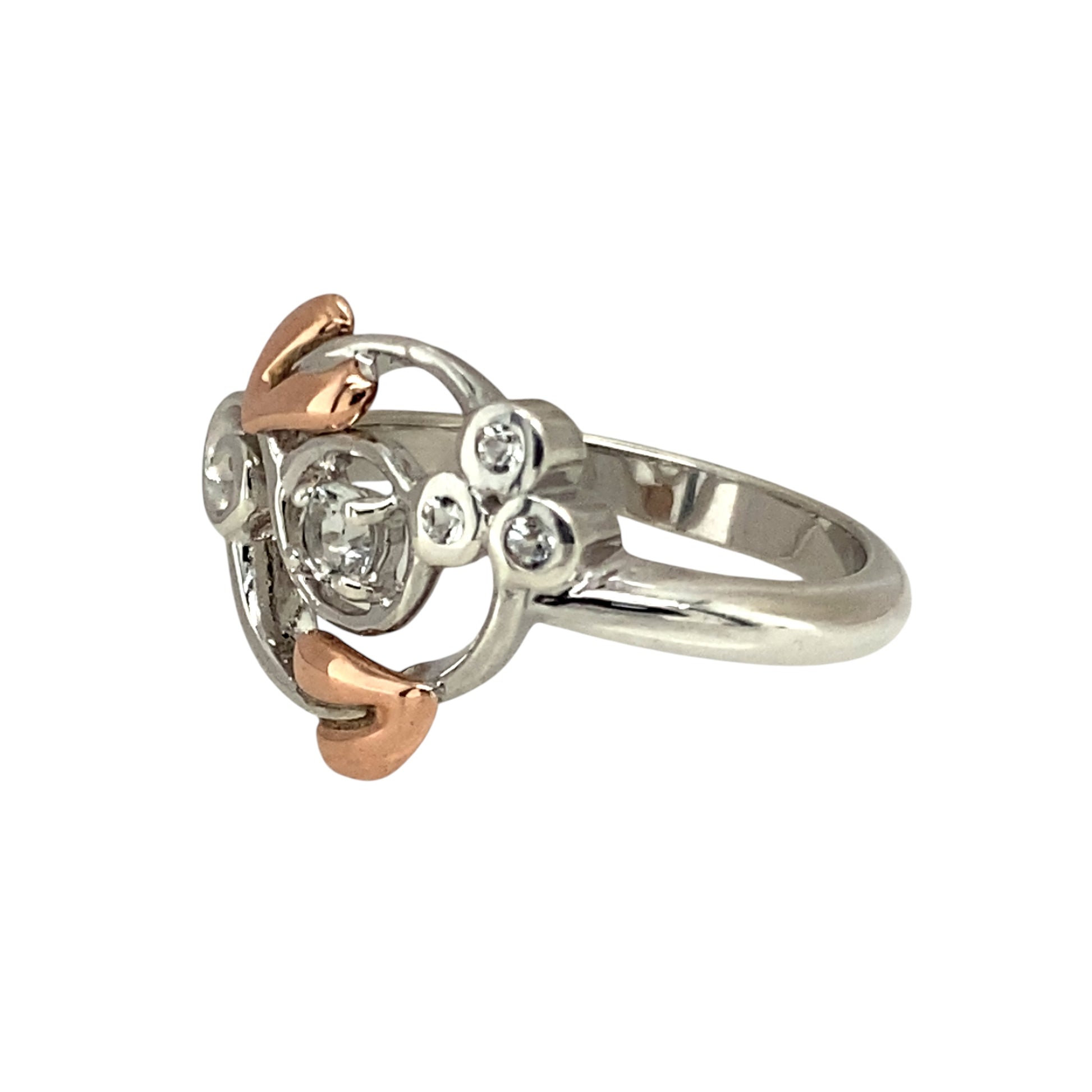 Elegant and symbolic, this pre-owned Clogau Tree of Life ring blends sterling silver, 9ct rose gold, and sparkling white topaz—perfect for meaningful style with a refined finish.

Design: The ring features a 3mm round white topaz stone at the centre, framed by a flowing Tree of Life design in 925 silver with delicate 9ct rose gold detailing.
Material: Made from sterling silver and 9-carat rose gold, the polished finish highlights the soft contrast between metals and the brilliance of the topaz.
