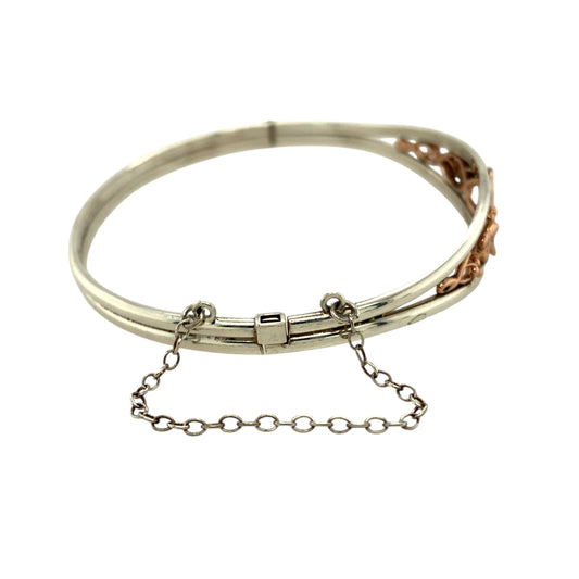 Preowned 925 Silver with 9ct Rose Gold Clogau Tree of Life Bangle with the weight 14.20 grams. The front of the ring is 12mm high and the bangle diameter is 6.5cm. The bangle has a safety chain