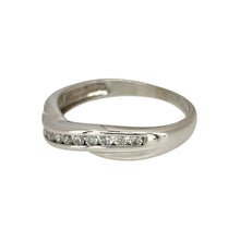 Load image into Gallery viewer, Add a touch of modern elegance to your jewellery collection with this pre-owned 9ct white gold &amp; diamond set crossover band ring, featuring:

Design: A stylish crossover band, offering a contemporary and sophisticated look.
Material: Crafted in 9-carat white gold, providing a sleek and polished finish.
Gemstone Detail: Accented with sparkling diamonds, adding brilliance and refinement.
Ring Width: Measures 3mm wide in the middle and 5mm wide on the sides, creating a dynamic and eye-catching design.

