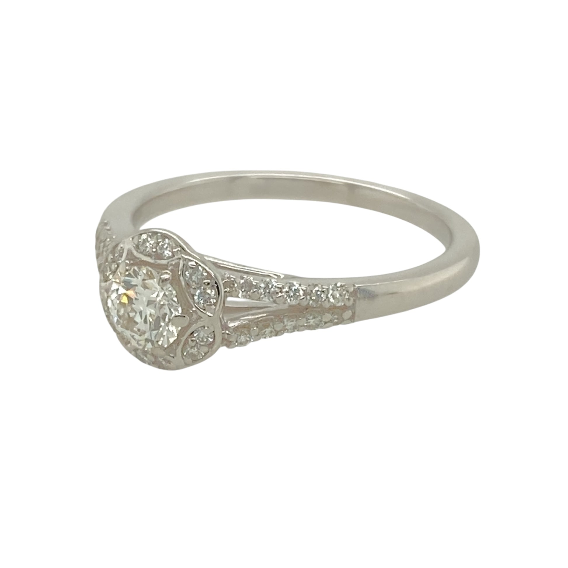 Add a touch of sparkle and sophistication to your jewellery collection with this pre-owned 9ct white gold and diamond set halo solitaire ring.

Design: Featuring a classic solitaire diamond encircled by a dazzling halo of smaller diamonds, this ring offers timeless elegance with added brilliance.
Material: Made from 9-carat white gold, providing a sleek and polished finish that enhances the beauty of the diamonds.
Diamond Detail: The halo setting amplifies the sparkle of the central stone