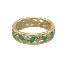 Load image into Gallery viewer, Add a touch of vibrant elegance to your jewellery collection with this pre-owned 9ct yellow gold diamond and emerald set open patterned band ring.

Design: Featuring an open patterned band design, this ring is set with stunning marquise-cut emeralds, complemented by sparkling diamonds for added brilliance.
Material: Made from 9-carat yellow gold, providing a warm and polished finish that enhances the gemstones.
Gemstone Detail: The emerald stones measure 4mm by 2mm each and are marquise cut
