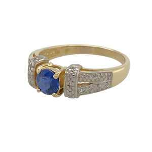 Add classic elegance to your jewellery collection with this pre-owned 9ct yellow gold diamond & sapphire-coloured stone set ring.

Design: A timeless setting that showcases a deep sapphire-coloured stone, complemented by delicate diamond accents for an elegant and refined look.
Material: Crafted from 9-carat yellow gold, offering a warm and classic finish that enhances the beauty of the gemstones.
Gemstone Detail: Features a striking 5mm round sapphire-coloured stone, radiating rich blue tones