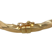 Load image into Gallery viewer, Add a stylish and elegant piece to your jewellery collection with this pre-owned 9ct yellow gold twisted bangle.

Design: A beautifully twisted design, offering a unique and sophisticated look with a subtle texture.
Material: Made from 9-carat yellow gold, providing a warm and polished finish that highlights the intricate twist.
Size &amp; Weight: Weighing 5.80 grams, the bangle has a width of 5mm and a diameter of 6.5cm, ensuring a comfortable and secure fit.

