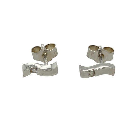 Add a touch of modern elegance to your jewellery collection with these pre-owned 9ct white gold and diamond set wave stud earrings, featuring:

Design: Sleek wave-shaped studs accented with sparkling diamonds, offering a contemporary yet timeless style.
Material: 9-carat white gold, providing a cool-toned, polished finish that enhances the brilliance of the diamonds.
Gemstone Detail: Set with delicate diamonds that add subtle sparkle to the flowing design.
