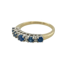 Load image into Gallery viewer, Introduce a touch of refined elegance to your jewellery collection with this pre-owned 9ct yellow gold band ring, beautifully accented with sapphire and diamond details, featuring:

Design: A timeless band style ring, enhanced with a central sapphire and delicate diamond accents for understated sophistication.
Material: Crafted in 9-carat yellow gold, offering a rich, polished finish and lasting appeal.

