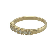 Load image into Gallery viewer, Bring classic sparkle and refined style to your collection with this pre-owned 9ct yellow gold diamond set seven stone band ring, offering elegant brilliance in a timeless setting—perfect for daily elegance or meaningful occasions.

Design: The front of the band features seven brilliant-cut diamonds totalling approximately 0.33 carats, set in a classic row for balanced sparkle and symmetry.
Material: Made from 9-carat yellow gold, the polished finish adds warmth and enhances the radiance of the diamonds
