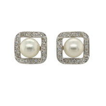 Load image into Gallery viewer, Add classic elegance with a modern twist to your collection with these pre-owned 14ct white gold diamond and pearl stud earrings—timeless sophistication with a touch of sparkle.

Design: Each earring features a lustrous 8mm round pearl at the centre, surrounded by a square frame set with sparkling diamonds in polished white gold for a striking contrast.
Material: Made from 14-carat white gold, the sleek, cool-toned finish enhances the brilliance of the diamonds and the natural beauty of the pearls.
