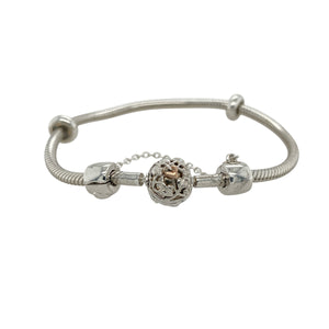 Blend timeless style with meaningful detail in this pre-owned Clogau 7.5" charm bracelet—crafted in 925 silver with 9ct rose gold accents for a beautifully finished and secure foundation for your charms.

Design: The bracelet features a classic charm bracelet design with two stopper charms to keep your collection in place, and a decorative ball-shaped safety link charm engraved with the signature Tree of Life pattern across the clasp.
