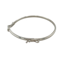 Load image into Gallery viewer, Add refined sparkle and modern elegance to your collection with this pre-owned 9ct white gold and cubic zirconia set bangle—sleek, understated, and perfect for everyday sophistication.

Design: The bangle features a slim front adorned with cubic zirconia stones, offering a delicate shimmer across its 3mm wide surface.
Material: Made from 9-carat white gold, the polished finish enhances the brilliance of the stones and provides a clean, contemporary look.

