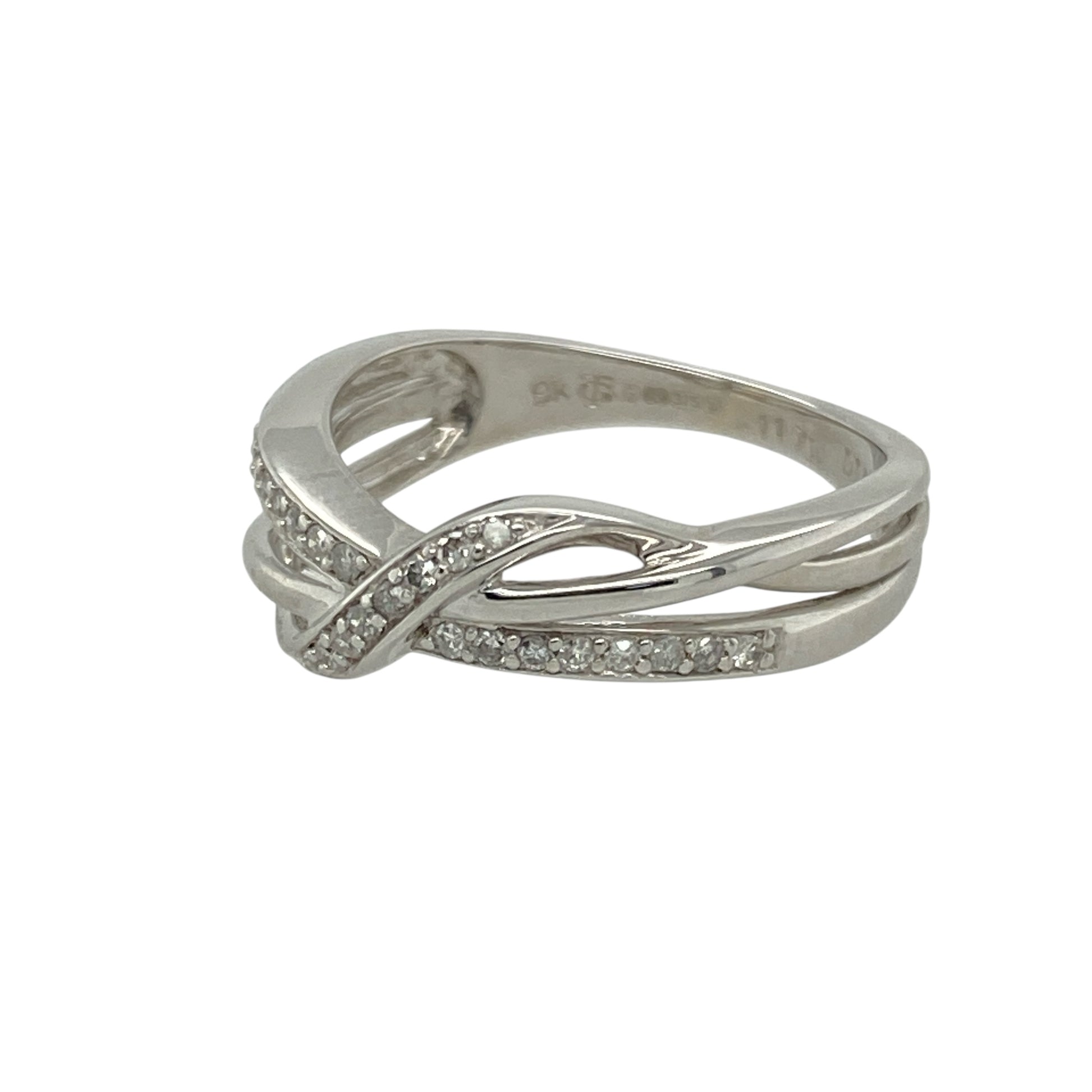 Add modern elegance and graceful sparkle to your collection with this pre-owned 9ct white gold diamond set wrap over band ring—stylish, refined, and perfect for contemporary wear. There is approximately 0.11ct of diamond content set in the band in total.

Design: The ring features a sleek 5mm wide wrap over design across the front of the band, set with diamonds that enhance the flowing shape and add subtle brilliance.
