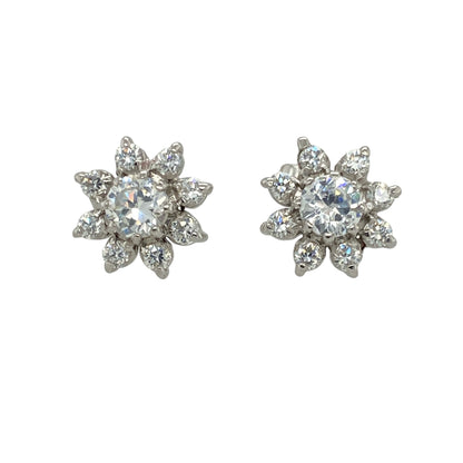 Bring delicate sparkle and floral charm to your jewellery collection with these pre-owned 9ct white gold flower stud earrings, featuring shimmering cubic zirconia stones in a timeless design—perfect for everyday elegance or subtle occasion wear.

Design: Each stud features a 4mm diameter cubic zirconia at the centre, surrounded by smaller stones arranged in a floral pattern. The design offers a soft, feminine look with eye-catching brilliance.
