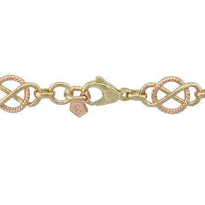 Bring bold heritage style and meaningful design to your collection with this pre-owned 9ct yellow and rose gold Clogau Celtic Infinity Knot necklace, showcasing striking craftsmanship and timeless symbolism—perfect for statement wear with lasting significance.

Design: This 20-inch necklace features a continuous arrangement of Celtic infinity knot links, each approximately 10mm wide, crafted in alternating yellow and rose gold. The iconic knot symbolises eternity, unity, and unbreakable connection.
