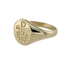 Load image into Gallery viewer, Celebrate tradition and bold design with this pre-owned 9ct yellow gold Welsh three feather oval signet ring—perfect for showcasing heritage with timeless style.

Design: The ring features a 13mm high oval face engraved with the iconic Welsh three feather emblem, offering a proud and recognisable symbol of identity.
Material: Made from 9-carat yellow gold, the polished finish enhances the fine detailing and adds a rich, classic glow.

