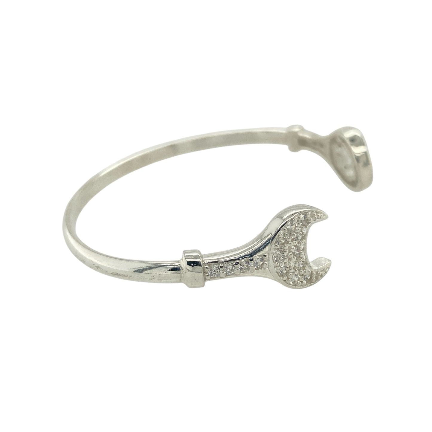 Bring playful personality and sparkling detail to a child’s jewellery collection with this new 925 silver and cubic zirconia set children's spanner bangle—a fun and unique piece with a touch of charm and shine.

Design: The front of the bangle features a detailed 11mm high spanner motif, accented with cubic zirconia stones for a hint of brilliance and whimsy.
Material: Made from solid 925 sterling silver, the polished finish provides a bright, smooth shine that enhances the playful design.

