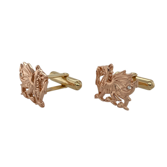 Bring bold symbolism and refined detail to your collection with these pre-owned 9ct rose and yellow gold diamond set Clogau Welsh Dragon cufflinks—striking and meaningful with a touch of luxury.

Design: Each cufflink features the iconic Welsh Dragon in rich detail, accented with a single sparkling diamond for subtle brilliance.
Material: Made from 9-carat rose and yellow gold, the warm tones reflect traditional Clogau styling with a distinctive heritage feel.
