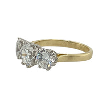 Load image into Gallery viewer, Bring radiant sparkle and classic style to your collection with this pre-owned 9ct yellow gold CZ trilogy ring, offering eye-catching brilliance and timeless charm—perfect for special occasions or everyday elegance.

Design: The ring showcases a 7mm round cubic zirconia at the centre, flanked by two smaller stones to create a balanced and refined trilogy look. The design delivers striking presence and a touch of modern sophistication.
Material: Made from 9-carat yellow gold, the warm, polished finish enhanc
