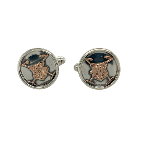 Bring refined elegance and distinctive heritage to your collection with these pre-owned 925 silver with 9ct rose gold Clogau Welsh Polo cufflinks, offering a sophisticated design and timeless charm—perfect for adding a polished finish to any formal look.

Design: The cufflinks feature a classic round shape accented with elegant 9ct rose gold detailing, inspired by the spirit of Welsh polo. Their subtle yet striking design adds a touch of personality and heritage to your attire.
