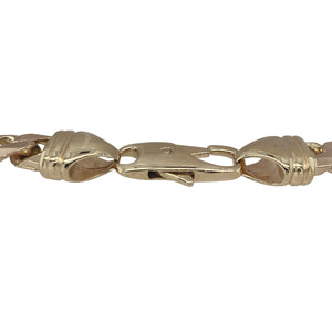 Bring bold presence and timeless craftsmanship to your collection with this pre-owned 9ct yellow gold 9.5" curb bracelet—a substantial and stylish piece with classic appeal.

Design: The bracelet features traditional flat curb links measuring 7mm wide, offering a sleek, polished look that drapes comfortably along the wrist.
Material: Made from 9-carat yellow gold, the high-shine finish enhances the strong link design and delivers a warm, rich glow.

