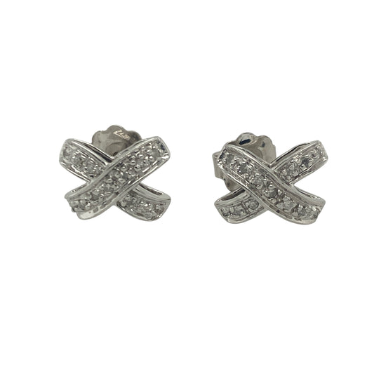 Bring subtle sparkle and romantic charm to your collection with these pre-owned 9ct white gold and diamond set kiss stud earrings—a delicate design with timeless elegance and symbolic style.

Design: The earrings feature an elegant "X" kiss shape, each set with sparkling diamonds for a refined, love-inspired look that’s perfect for any occasion.
Material: Made from 9-carat white gold, the polished finish enhances the brilliance of the diamonds and offers a cool, modern shine.
