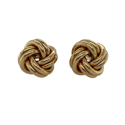 Classic and stylish, these pre-owned 9ct yellow gold knot stud earrings offer timeless elegance with a bold twist—perfect for elevating everyday looks or adding polish to special occasions.

Design: Each earring features a 14mm knot design, symbolising unity and eternity, with smooth, interwoven loops creating a refined and dimensional look.
Material: Made from 9-carat yellow gold, the polished finish enhances the soft curves and classic shine of the design.

