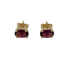 Load image into Gallery viewer, Bring vibrant colour and classic elegance to your jewellery collection with these pre-owned 9ct yellow gold stud earrings, featuring rich purple stones in a timeless oval cut—perfect for everyday wear or subtle evening sparkle.

Design: Each earring features a 6mm by 4mm oval-cut purple stone, offering a refined pop of colour in a clean, understated setting.
Material: Made from 9-carat yellow gold, the polished finish provides a warm contrast to the vivid tone of the stones.

