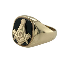 Load image into Gallery viewer, Bring symbolic heritage and bold style to your jewellery collection with this pre-owned 9ct yellow gold Masonic signet ring, featuring a polished onyx centre—perfect for making a statement with meaning.

Design: The ring features a 14mm high face set with smooth black onyx, inlaid with the iconic Masonic emblem for a distinctive and recognisable look.
Material: Made from 9-carat yellow gold, the polished finish enhances the rich golden tone and contrasts beautifully with the deep black onyx.

