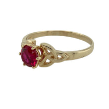 Load image into Gallery viewer, Bring rich colour and symbolic detail to your jewellery collection with this pre-owned 9ct yellow gold ruby set Celtic knot design ring—perfect for adding meaning and elegance to any look.

Design: The ring features a 7mm diameter ruby-coloured stone at the centre, framed by an intricate Celtic knot design that symbolises eternity and interconnectedness.
Material: Made from 9-carat yellow gold, the polished finish enhances the warm golden tone and complements the deep red of the stone.

