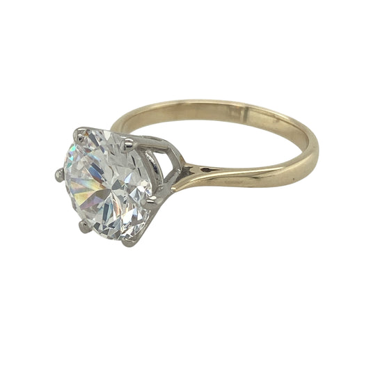 Bring bold sparkle and timeless style to your collection with this pre-owned 9ct yellow gold cubic zirconia solitaire dress ring, a striking piece perfect for making a statement.

Design: The ring features a brilliant 10mm round cubic zirconia stone at the centre, offering eye-catching sparkle in a classic solitaire style.
Material: Made from 9-carat yellow gold, the polished finish enhances the brilliance of the stone with a warm and refined glow.