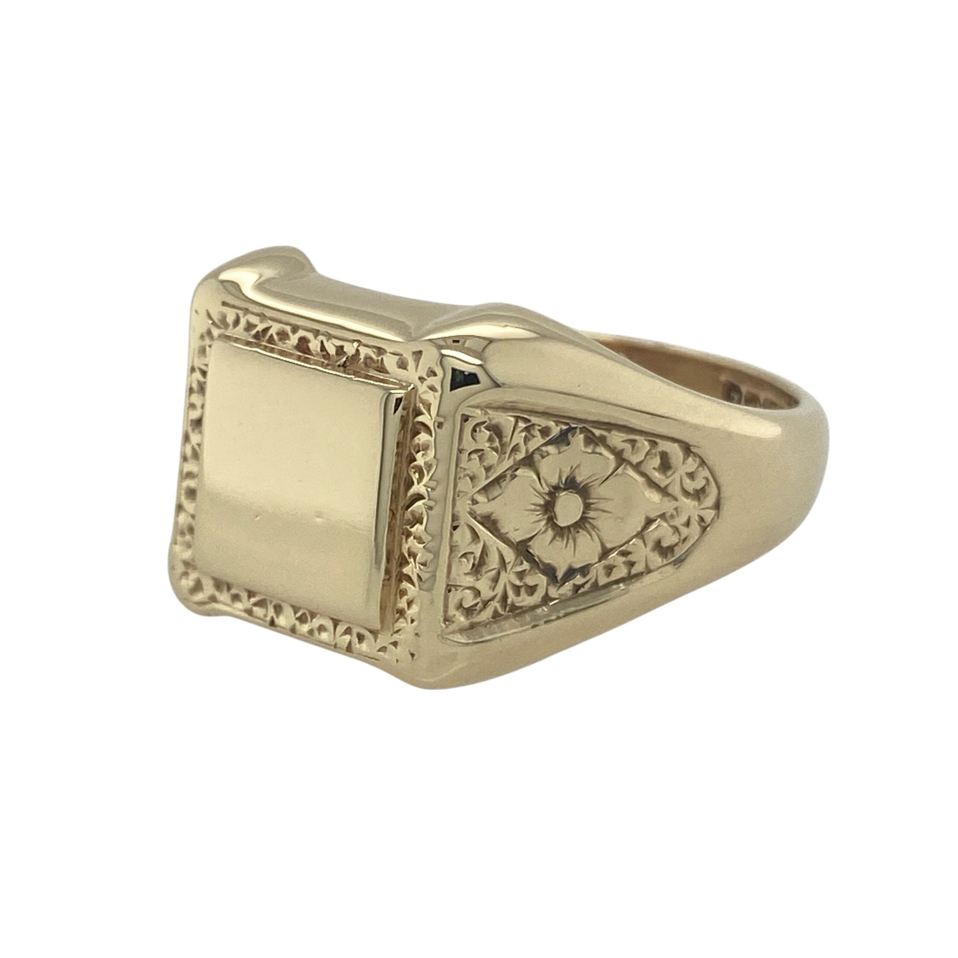 Bring bold style and detailed design to your collection with this pre-owned 9ct yellow gold square signet ring, featuring patterned shoulders and surround for a distinctive finish.

Design: The ring features a 14mm high square-shaped front with decorative surround and shoulders, adding texture and character to a traditional signet profile.
Material: Made from 9-carat yellow gold, the polished finish enhances the detailing while giving the piece a warm and refined glow.
