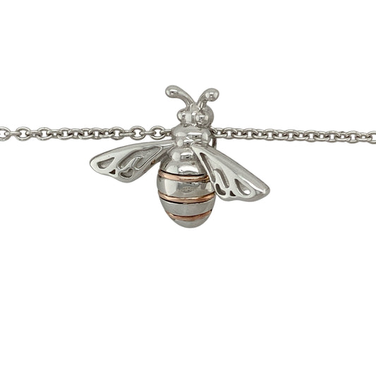 Bring nature-inspired charm and golden detail to your collection with this pre-owned Clogau honey bee pendant in silver and 9ct rose gold, paired with an adjustable belcher chain for versatile wear.

Design: The pendant measures 2.2cm long and features a delicately detailed honey bee motif, symbolising community, diligence, and nature’s beauty, highlighted with 9ct rose gold accents.