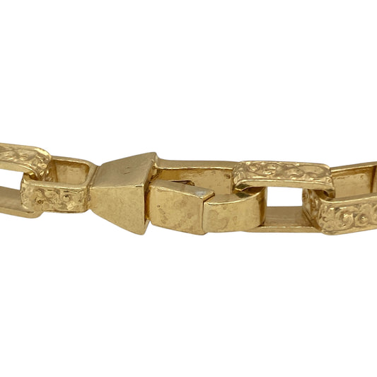 Bring refined style and luxurious warmth to your collection with this new solid 925 silver heavily 9ct gold plated patterned rectangle link bracelet, a sophisticated design with timeless appeal.

Design: The bracelet measures 8.5 inches in length with 6mm wide rectangular links featuring detailed patterning, creating a sleek and elegant look.
Material: Made from solid 925 sterling silver with a heavy 9ct gold plating, the polished finish enhances the golden tone and highlights the fine link craftsmanship.