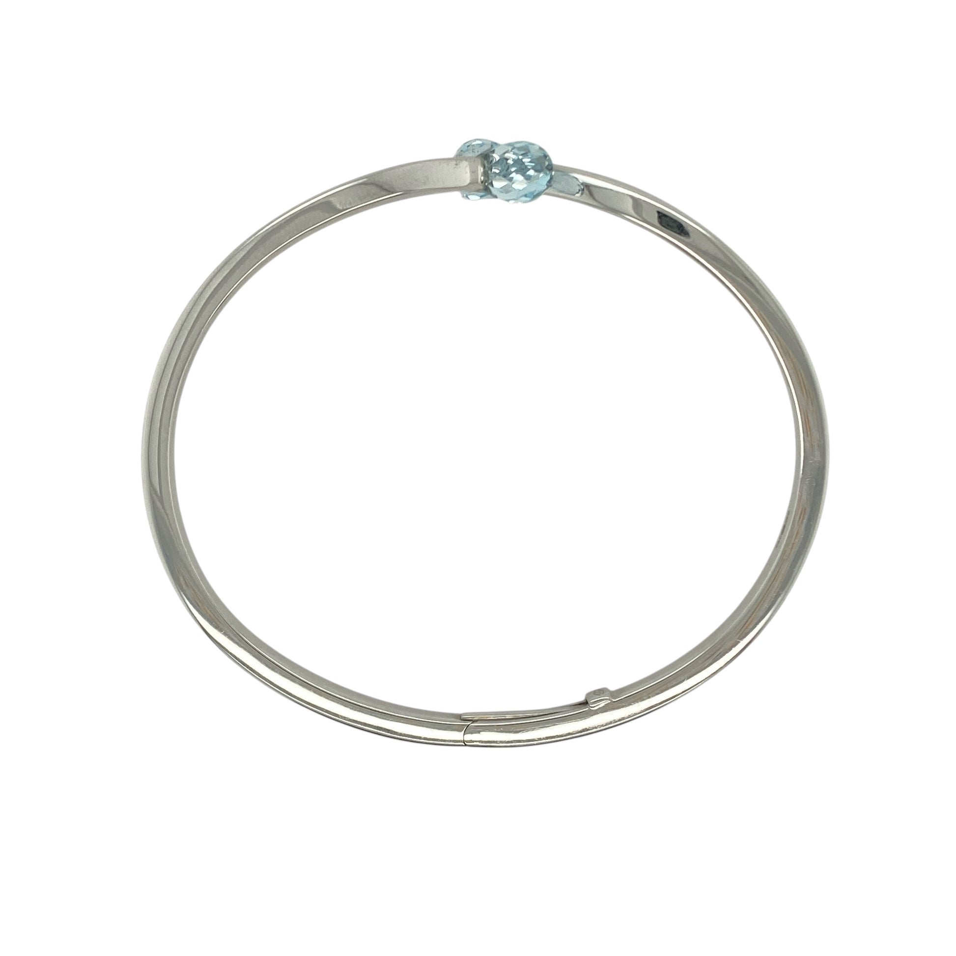 Bring contemporary elegance and serene colour to your collection with this pre-owned 9ct white gold and aqua stone wrap-over torque cuff-style bangle, combining modern design with timeless sophistication—perfect for both everyday wear and special occasions.

Design: The bangle features a stylish open torque cuff design with two blue aqua-coloured stones, each measuring 9mm by 6mm, gracefully positioned at either end for a balanced and eye-catching look.