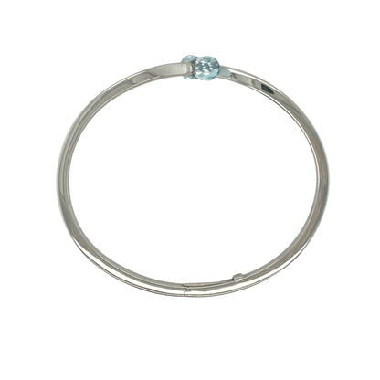 Bring contemporary elegance and serene colour to your collection with this pre-owned 9ct white gold and aqua stone wrap-over torque cuff-style bangle, combining modern design with timeless sophistication—perfect for both everyday wear and special occasions.

Design: The bangle features a stylish open torque cuff design with two blue aqua-coloured stones, each measuring 9mm by 6mm, gracefully positioned at either end for a balanced and eye-catching look.