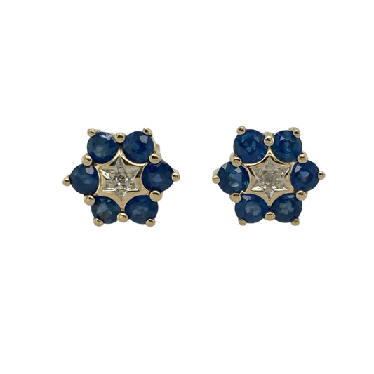 Bring classic elegance and floral charm to your look with these pre-owned 9ct yellow gold diamond and sapphire set flower stud earrings—perfect for adding timeless sparkle and colour to any occasion.

Design: Each earring features a delicate flower design with six 3mm round blue sapphires forming the petals and a sparkling diamond set at the centre, creating a refined and balanced look full of colour and brilliance.