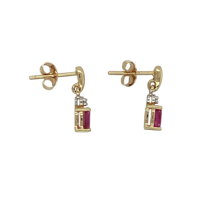 Add a touch of classic elegance and vibrant colour to your collection with these pre-owned 9ct yellow gold diamond and ruby set drop earrings — a graceful design that combines timeless beauty with refined sparkle.

Design: Each earring features a 5mm by 3mm ruby stone suspended beneath a sparkling diamond, creating a delicate drop style that moves beautifully and catches the light with every turn.