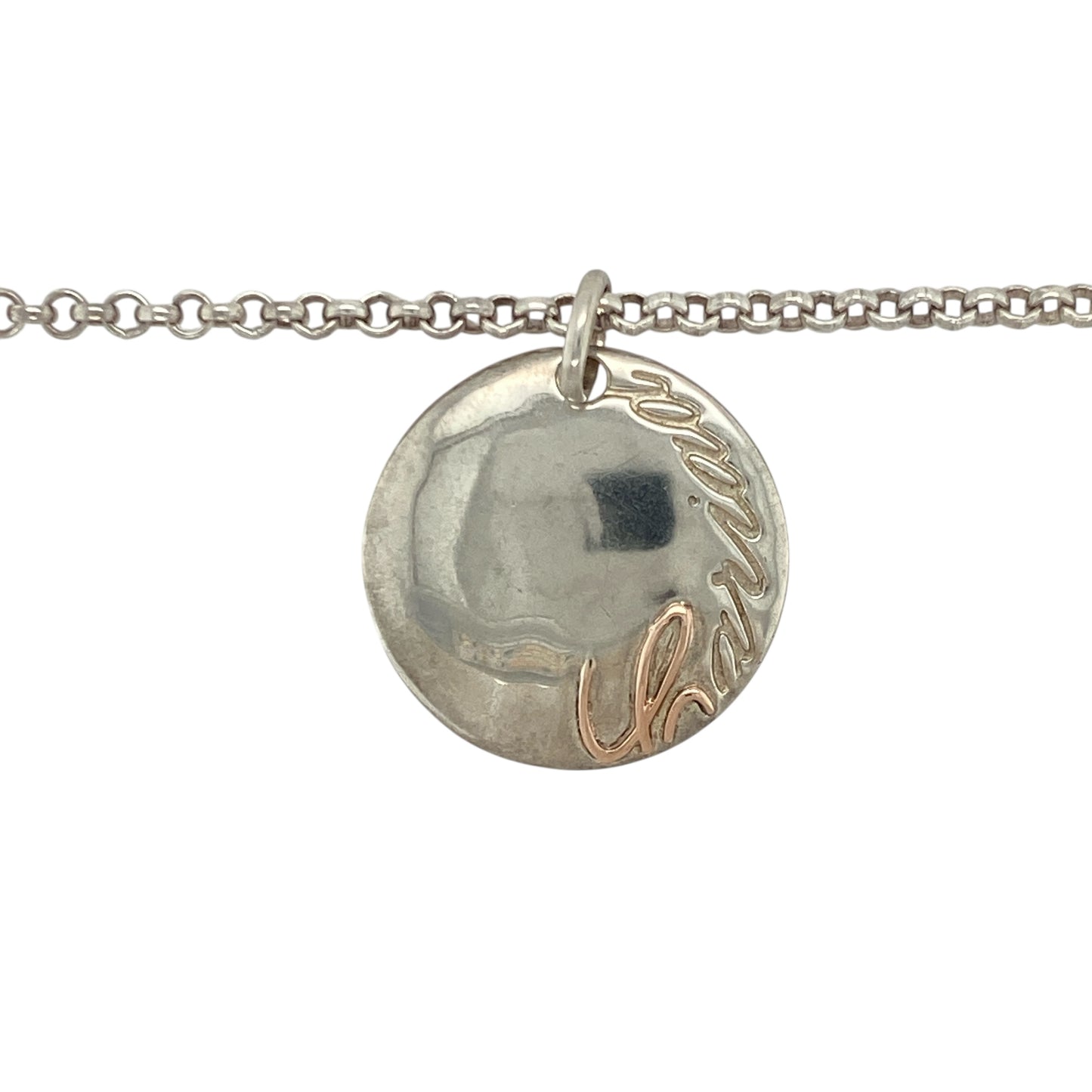 Add heartfelt meaning and elegant simplicity to your collection with this pre-owned 925 silver and 9ct rose gold Clogau Cariad disc pendant necklace — a timeless design that beautifully expresses love and connection.

Design: The pendant features a polished silver disc engraved with the Welsh word “Cariad”, meaning “love”, accented with Clogau’s signature 9ct rose gold detailing. Measuring 23mm in diameter, it offers a graceful, contemporary look with sentimental charm.