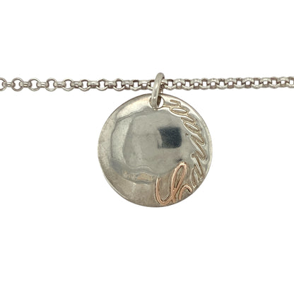 Add heartfelt meaning and elegant simplicity to your collection with this pre-owned 925 silver and 9ct rose gold Clogau Cariad disc pendant necklace — a timeless design that beautifully expresses love and connection.

Design: The pendant features a polished silver disc engraved with the Welsh word “Cariad”, meaning “love”, accented with Clogau’s signature 9ct rose gold detailing. Measuring 23mm in diameter, it offers a graceful, contemporary look with sentimental charm.