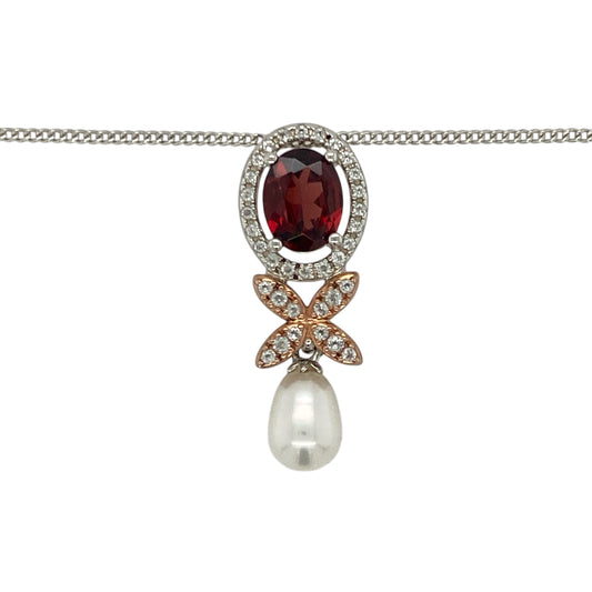 Add vibrant colour and nature-inspired elegance to your collection with this pre-owned 925 silver and 9ct rose gold Clogau Jubilee Superbloom butterfly-style drop pendant necklace — a graceful design celebrating beauty and renewal.

Design: The pendant features a stunning butterfly motif adorned with garnet, pearl, and white topaz stones, combining rich colour and delicate sparkle. Measuring 3cm long, the design captures movement and light, symbolising transformation and growth.