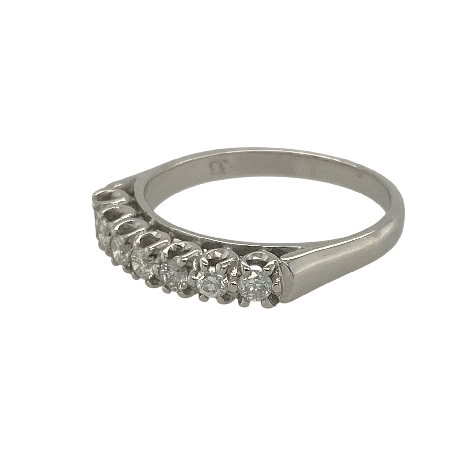 Pre-owned 18ct White Gold &amp; Diamond Set Band Ring in size P with the weight 3.60 grams. There are seven brilliant cut diamonds in the band at approximately 0.33ct of diamond content set in total