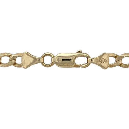 Bring bold shine and warm golden tone to your collection with this pre-owned 9ct yellow gold curb chain—an enduring classic offering strength, presence, and timeless style.

Design: This 22" curb chain features 4mm flat links that create a sleek, substantial profile with a smooth, confident drape.
Material: Made from 9-carat yellow gold, the chain boasts a polished finish that enhances its bright, eye-catching glow.