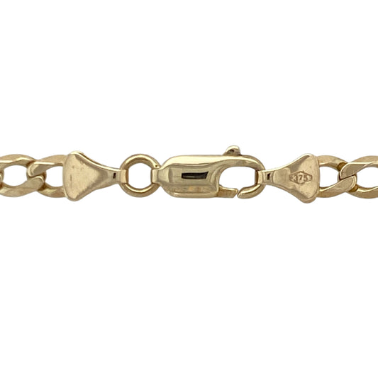 Bring bold shine and warm golden tone to your collection with this pre-owned 9ct yellow gold curb chain—an enduring classic offering strength, presence, and timeless style.

Design: This 22" curb chain features 4mm flat links that create a sleek, substantial profile with a smooth, confident drape.
Material: Made from 9-carat yellow gold, the chain boasts a polished finish that enhances its bright, eye-catching glow.