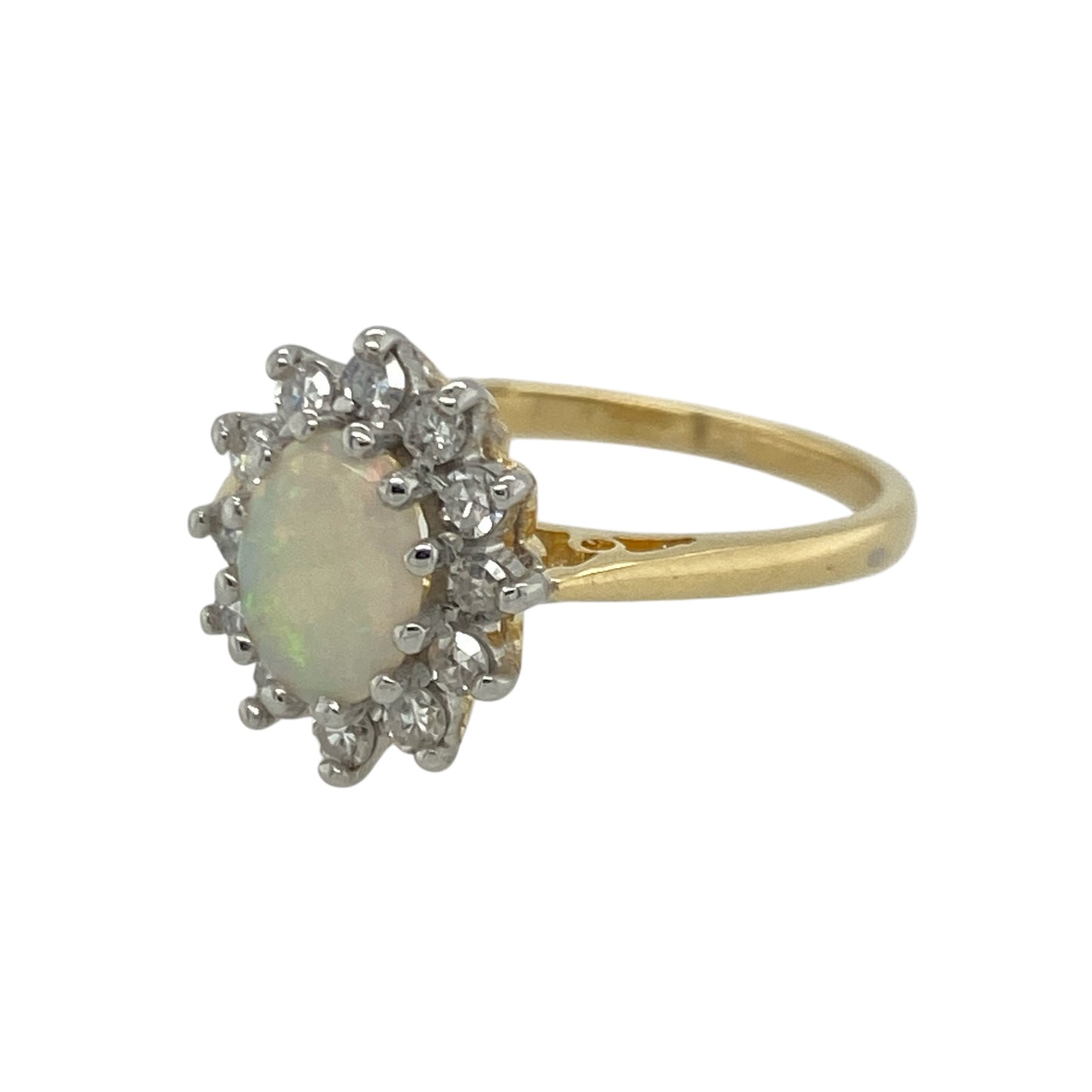 Bring luminous colour and timeless elegance to your collection with this pre-owned 18ct yellow gold diamond and opal cluster ring—an enchanting piece offering refined sparkle and captivating beauty.

Design: This size K–L ring features a 7mm by 5mm oval opal at the centre, displaying its natural play of colour, surrounded by a halo of diamonds that enhance its iridescent glow.
Material: Made from 18-carat yellow gold