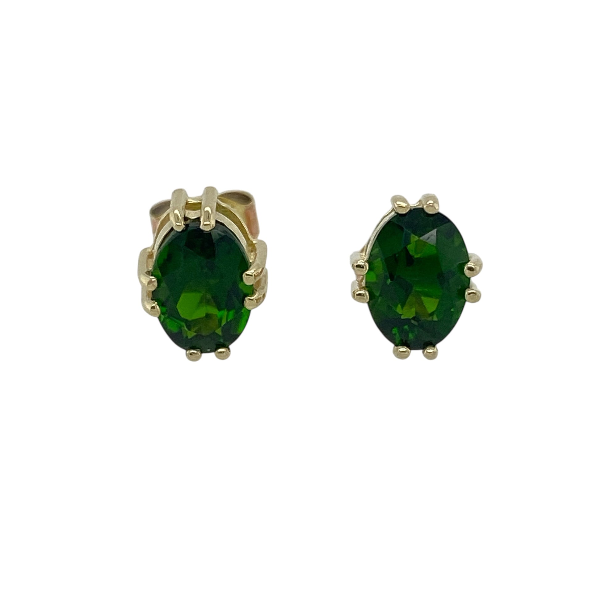 Bring rich colour and refined elegance to your accessory collection with these pre-owned 9ct gold oval green stone stud earrings — a vibrant pair with timeless appeal.

Design: Each earring features a 7mm by 5mm oval chrome-diopside–coloured green stone, offering deep, vivid colour in a classic and eye-catching stud style.
Material: Made from 9ct gold, the polished finish provides a warm contrast that enhances the striking green tones of the stones.