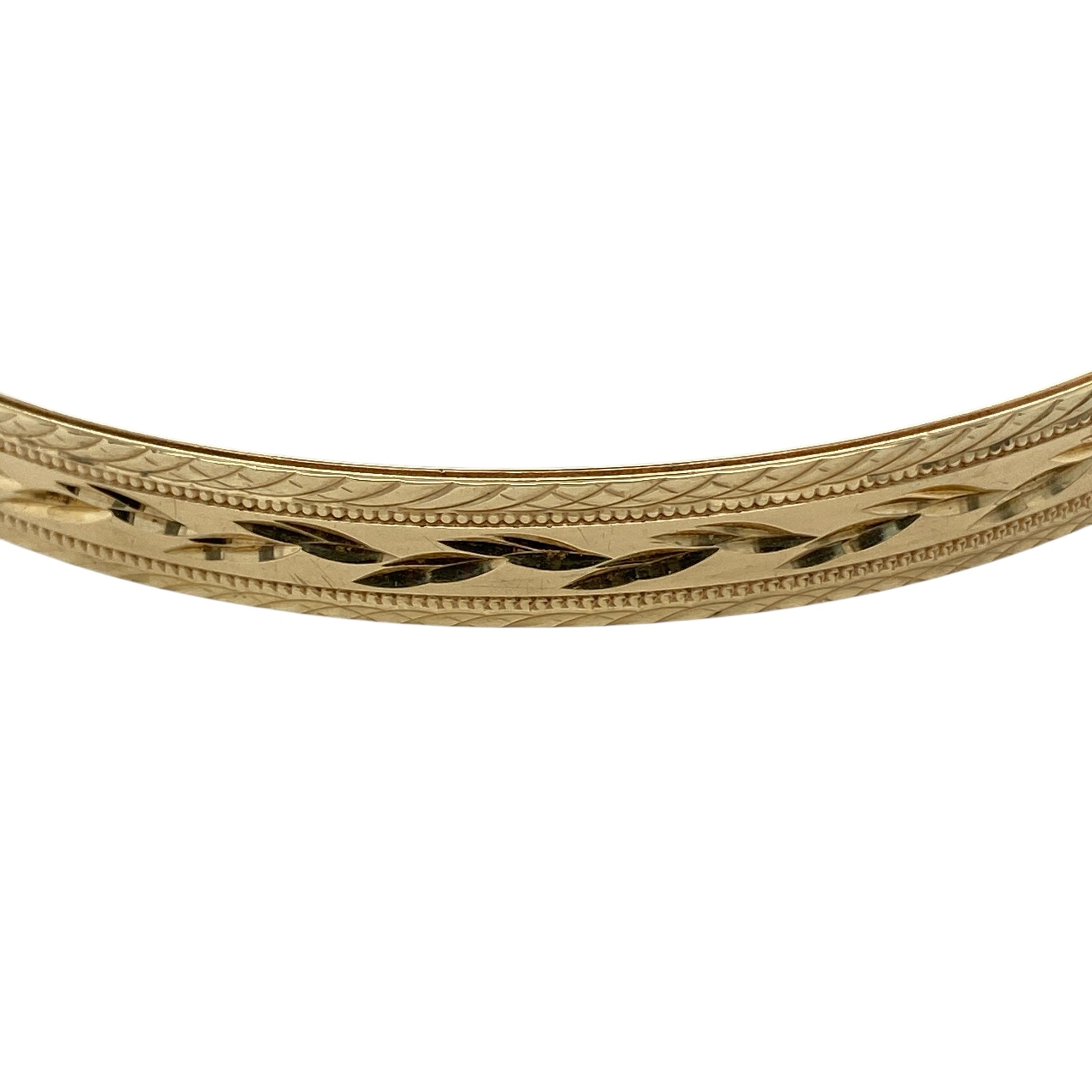 Bring classic elegance and timeless texture to your jewellery collection with this pre-owned 9ct yellow solid gold patterned bangle, a refined piece that combines traditional design with everyday versatility.

Design: The bangle features an all-over patterned finish, adding subtle texture and visual interest to its clean, solid profile. Measuring approximately 6.5mm in width, it offers a balanced and elegant presence on the wrist.