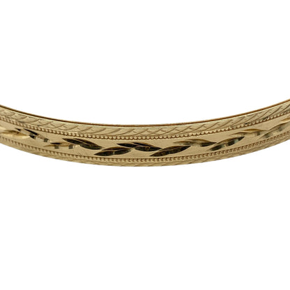 Bring classic elegance and timeless texture to your jewellery collection with this pre-owned 9ct yellow solid gold patterned bangle, a refined piece that combines traditional design with everyday versatility.

Design: The bangle features an all-over patterned finish, adding subtle texture and visual interest to its clean, solid profile. Measuring approximately 6.5mm in width, it offers a balanced and elegant presence on the wrist.