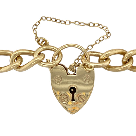 Bring bold elegance and timeless charm to your jewellery collection with this pre-owned 9ct yellow gold heart padlock curb charm bracelet, a classic and substantial piece with enduring appeal.

Design: The bracelet features a traditional curb link style with a heart-shaped padlock clasp, creating a recognisable and elegant look. The links measure approximately 8mm wide, giving the bracelet a strong and confident presence.