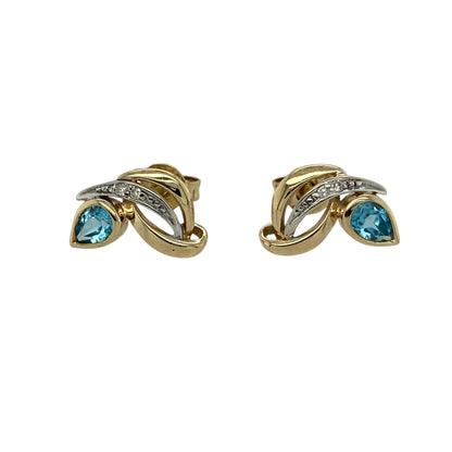 Bring delicate colour and refined sparkle to your jewellery collection with these pre-owned 9ct yellow gold diamond & blue topaz set stud earrings, a graceful design with timeless appeal.

Design: Each stud features a teardrop-shaped blue topaz measuring 4mm by 2mm, accented with diamonds that add subtle brilliance and enhance the elegant silhouette.
Material: Made from polished 9-carat yellow gold, the warm tone beautifully complements the cool blue of the topaz and the sparkle of the diamonds.